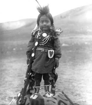 Title Nez Perce boy, Colville Indian Reservation, Washington, ca. 1903. Photographer Latham, Edward H. Studio Location United States--Washington (State)--Nespelem Date ca. 1903 Notes Young boy stands outside on blanket. He wears feathers and decorations in his hair, long shirt over leggings, beaded moccasins, necklaces, bracelet, vest, and leather pouch attached to belt. A sash with ornaments is draped across his chest. Caption on negative sleeve: Little Indian boy dolled up. Note from unidentified source: Young Nez Perce boy. Subjects Portraits--Washington (State) Nez Perce Indians--Clothing & dress Nez Perce Indians--Children Blankets Bags Location Depicted United States--Washington (State)--Colville Indian Reservation Object Type Photographs Negative Number NA1010 Collection Edward H. Latham Collection no. 409 Repository University of Washington Libraries. Special Collections Division